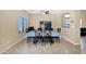 The dining room includes a table set for six, a ceiling fan, and natural light from the windows at 2519 W Burgess Ln, Phoenix, AZ 85041