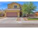 Charming two-story home with a brown two-car garage and a meticulously landscaped front yard at 2519 W Burgess Ln, Phoenix, AZ 85041