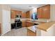 Traditional kitchen featuring wooden cabinets, stainless steel appliances, and tile floors at 2519 W Burgess Ln, Phoenix, AZ 85041