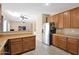 Bright kitchen showcasing stainless steel refrigerator and open layout, flowing into the living area at 2519 W Burgess Ln, Phoenix, AZ 85041