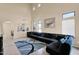 Open-concept living room featuring high ceilings, tile flooring, and access to the dining area at 2519 W Burgess Ln, Phoenix, AZ 85041