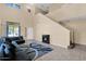 High-ceiling living room with a staircase, tile flooring, and a cozy fireplace at 2519 W Burgess Ln, Phoenix, AZ 85041