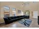 Bright, spacious living room with high ceilings, tile flooring, and a large sectional sofa at 2519 W Burgess Ln, Phoenix, AZ 85041