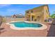 Backyard featuring a kidney-shaped pool with a safety fence and a covered patio of the house at 2519 W Burgess Ln, Phoenix, AZ 85041