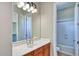 Bathroom featuring a sink, a large mirror, and shower/tub combo at 26703 N 90Th Dr, Peoria, AZ 85383