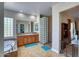 Bathroom featuring dual sinks, bathtub, glass block shower and tile flooring at 26703 N 90Th Dr, Peoria, AZ 85383