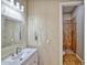 Bathroom featuring modern vanity, a mirror with decorative border, and a tiled walk-in shower at 26703 N 90Th Dr, Peoria, AZ 85383