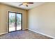 Bedroom featuring carpet flooring and a sliding glass door to the balcony at 26703 N 90Th Dr, Peoria, AZ 85383