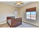Bedroom with a ceiling fan and a view through the windows at 26703 N 90Th Dr, Peoria, AZ 85383