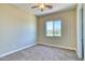 Well-lit bedroom with carpet floors and a view to the outside at 26703 N 90Th Dr, Peoria, AZ 85383
