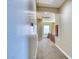 Bright hallway with neutral tones, leading to a window letting in natural light at 26703 N 90Th Dr, Peoria, AZ 85383