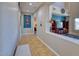 Bright hallway with tile flooring leading to an open living space and bedrooms at 26703 N 90Th Dr, Peoria, AZ 85383
