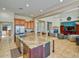 Open-concept kitchen featuring a large island with granite countertops, stainless steel appliances, and ample cabinet space at 26703 N 90Th Dr, Peoria, AZ 85383