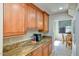 Kitchen cabinetry with granite countertops and under cabinet lighting at 26703 N 90Th Dr, Peoria, AZ 85383