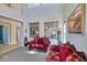 Elegant living room with tall ceilings, wrought iron decor, and plush seating, creating a comfortable atmosphere at 26703 N 90Th Dr, Peoria, AZ 85383