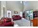 Spacious living room with tall ceilings, large windows, and plush seating, creating a bright and airy atmosphere at 26703 N 90Th Dr, Peoria, AZ 85383
