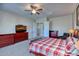 Main bedroom featuring a large bed, a ceiling fan, and built-in dressers at 26703 N 90Th Dr, Peoria, AZ 85383