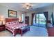 Main bedroom with backyard access, ceiling fan, and ensuite bathroom at 26703 N 90Th Dr, Peoria, AZ 85383