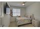 Bright bedroom with a ceiling fan, TV, and window, creating a cozy and inviting atmosphere at 2754 S Apache Dr, Chandler, AZ 85286