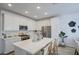 Bright kitchen with white cabinetry, stainless steel appliances, and a large island with seating for casual dining at 2754 S Apache Dr, Chandler, AZ 85286