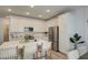 Well-lit kitchen with white cabinets, stainless steel appliances, and a large center island with barstool seating at 2754 S Apache Dr, Chandler, AZ 85286