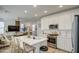 Open concept kitchen with stainless steel appliances, modern white countertops, and seamless flow to living area at 2754 S Apache Dr, Chandler, AZ 85286