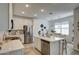 Modern kitchen with white cabinets, stainless steel appliances, and a spacious island and an open dining area at 2754 S Apache Dr, Chandler, AZ 85286