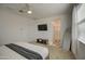 Spacious bedroom with TV, access to main bathroom with glass shower, and bright white paint at 2754 S Apache Dr, Chandler, AZ 85286