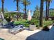 Inviting outdoor lounge space with chairs, umbrellas, and lush landscaping, perfect for relaxation and enjoying the outdoors at 2754 S Apache Dr, Chandler, AZ 85286