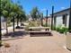 Community picnic area with shaded seating, desert landscaping, and gravel ground cover at 2754 S Apache Dr, Chandler, AZ 85286