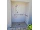 Modern tiled shower stall featuring safety bars and updated fixtures, with an easy access tile floor at 2754 S Apache Dr, Chandler, AZ 85286