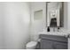 Well-lit half bathroom with a gray vanity and modern fixtures at 286 E Raleigh Dr, Chandler, AZ 85286