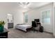 Bedroom with carpet, ceiling fan and a view into an attached bathroom at 286 E Raleigh Dr, Chandler, AZ 85286