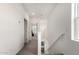 Bright hallway featuring neutral walls and carpet with views into other rooms of the house at 286 E Raleigh Dr, Chandler, AZ 85286