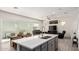 Open floor plan with kitchen island, dining table, and a comfortable living room at 286 E Raleigh Dr, Chandler, AZ 85286