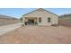 Home backyard featuring a sliding glass door and concrete area for outdoor dining at 30777 W Whitton Ave, Buckeye, AZ 85396