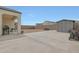 A large backyard with a concrete patio, gravel landscaping, and a storage shed at 30777 W Whitton Ave, Buckeye, AZ 85396
