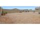 A gravel backyard featuring a block wall, a storage shed, and ample space at 30777 W Whitton Ave, Buckeye, AZ 85396