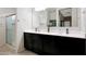 Bathroom featuring double sinks and a glass-enclosed shower at 30777 W Whitton Ave, Buckeye, AZ 85396