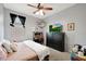 A bright bedroom with a ceiling fan, a cozy bed, and a dedicated workspace at 30777 W Whitton Ave, Buckeye, AZ 85396