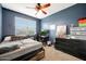 Bedroom with a bed, desk, and a dresser at 30777 W Whitton Ave, Buckeye, AZ 85396