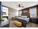 Bedroom with a ceiling fan, large bed, and an attached bathroom with double sinks at 30777 W Whitton Ave, Buckeye, AZ 85396