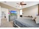 Bedroom with a ceiling fan, large bed, and a TV on a dresser at 30777 W Whitton Ave, Buckeye, AZ 85396