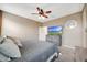 Bedroom with a ceiling fan, large bed, and a TV on a dresser at 30777 W Whitton Ave, Buckeye, AZ 85396