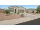 Single-story home featuring a two-car garage and a desert landscape at 30777 W Whitton Ave, Buckeye, AZ 85396