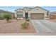 Inviting single-story home with a two-car garage and desert landscaping in front at 30777 W Whitton Ave, Buckeye, AZ 85396