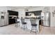 Modern kitchen featuring granite countertops, stainless steel appliances, and stylish black cabinetry at 30777 W Whitton Ave, Buckeye, AZ 85396