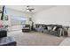Comfortable living room featuring neutral decor, large sofa and sliding glass doors to the backyard at 30777 W Whitton Ave, Buckeye, AZ 85396