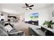 Spacious living room with a fireplace, TV, ceiling fan, and open floor plan at 30777 W Whitton Ave, Buckeye, AZ 85396