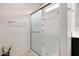 Modern shower with sliding glass door and built-in shelving at 30777 W Whitton Ave, Buckeye, AZ 85396